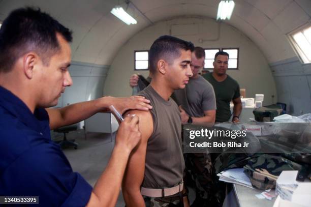 Military personnel line up to get an injection by medical staff at Camp Pendleton, December 3, 1992 in Oceanside, California.