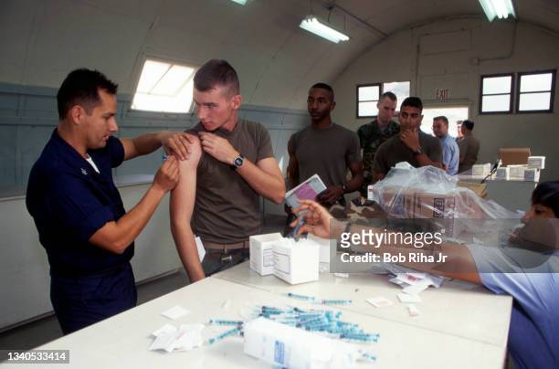 Military personnel line up to get an injection by medical staff at Camp Pendleton, December 3, 1992 in Oceanside, California.