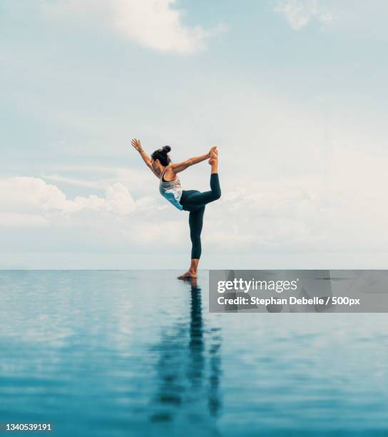 woman practicing yoga at beach against sky,bora bora,french polynesia - self discipline imagens e fotografias de stock