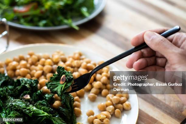 eating vegan food - chick pea salad stock pictures, royalty-free photos & images
