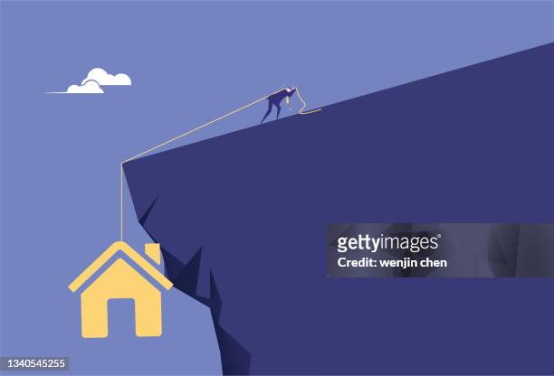 ilustraciones, imágenes clip art, dibujos animados e iconos de stock de hombre de negocios se esfuerza por no dejar que la casa se caiga del acantilado - dragging