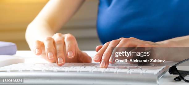 women's hands type text on the keyboard of a computer or laptop. an office worker at his desk. next to the computer mouse, notepad, glasses. the concept of business, freelancing, working at home. banner. - iscrizione nelle liste elettorali foto e immagini stock