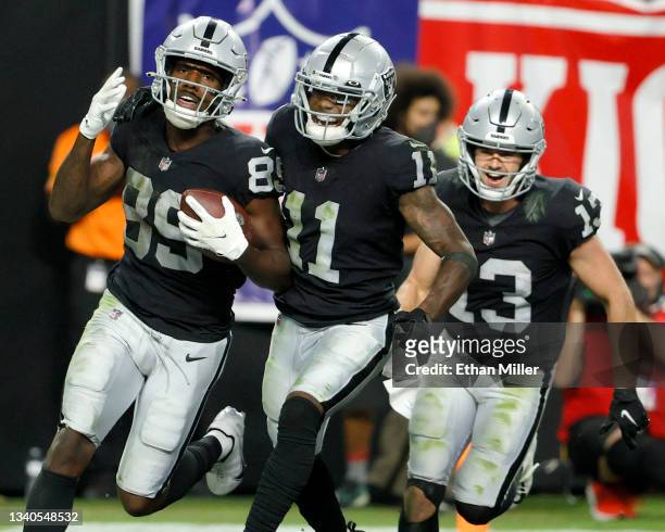 Bryan Edwards of the Las Vegas Raiders celebrates with Henry Ruggs III and Hunter Renfrow after scoring a touchdown that was called down at the...
