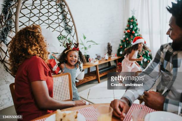 family celebrating christmas at home and having fun at the table for breakfast - christmas breakfast stock pictures, royalty-free photos & images
