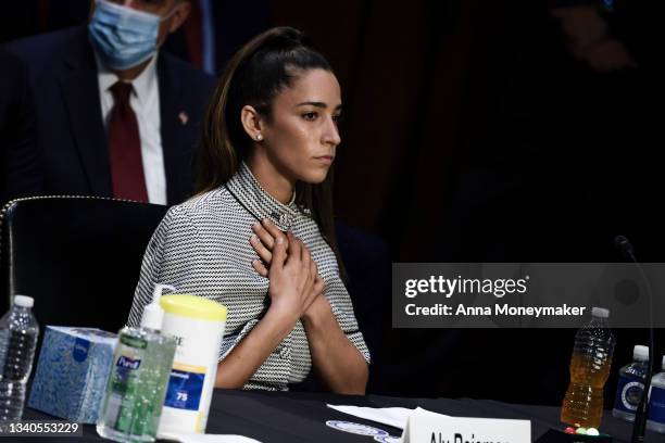 Olympic Gymnast Aly Raisman closes her eyes as NCAA and world champion gymnast Maggie Nichols gives her testimony during a Senate Judiciary hearing...