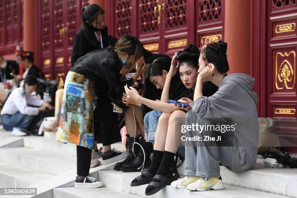 Models prepare backstage before the IS.CHAO & YUE BAST collection show by designers Zhang Yichao and Wang Shuer on day one of 2021 Beijing Fashion...