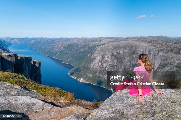 girl admiring the fjord norway - valley side stock-fotos und bilder