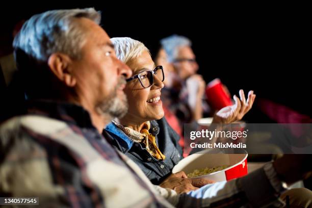 senior couple watching and discussing a movie at the cinema - old film stock pictures, royalty-free photos & images