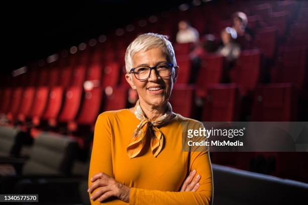 portrait of a happy senior woman at the cinema - film premiere stock pictures, royalty-free photos & images