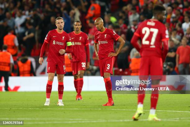 Jordan Henderson and Fabinho of Liverpool look dejected after conceding a goal during the UEFA Champions League group B match between Liverpool FC...