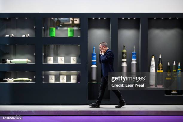 Man walks past a display case of munitions manufactured by the Rheinmetall company on day two of the DSEI exhibition at ExCel on September 15, 2021...