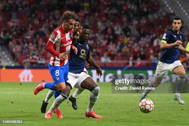 Chancel Mbemba of FC Porto commits a foul on Antoine Griezmann of Atletico Madrid and is later shown a red card during the UEFA Champions League...