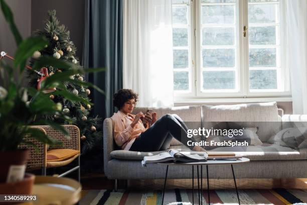 beautiful woman using mobile phone at home - living room window stock pictures, royalty-free photos & images