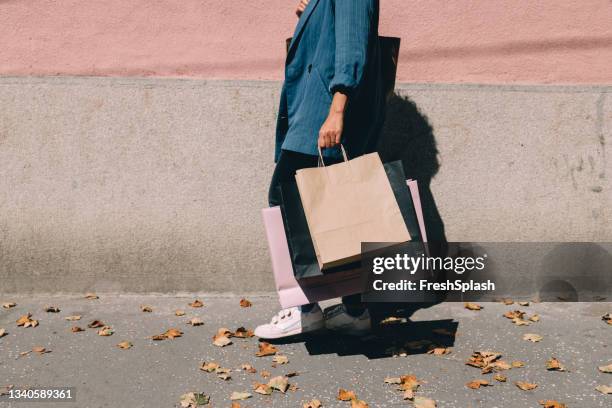 an anonymous woman in shopping - woman walks down street stock pictures, royalty-free photos & images