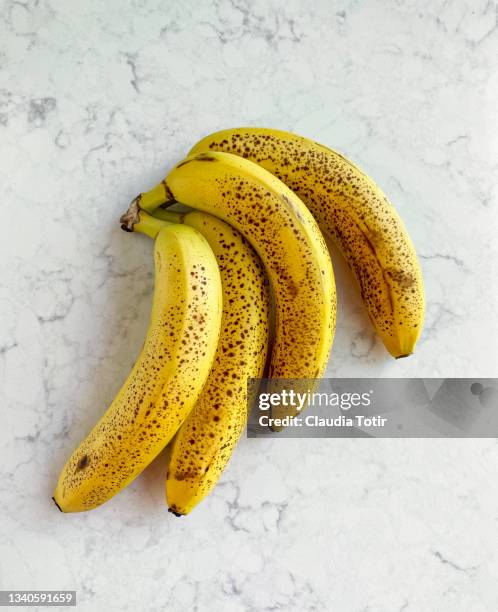 ripe bananas on white, marble background - banana ストックフォトと画像