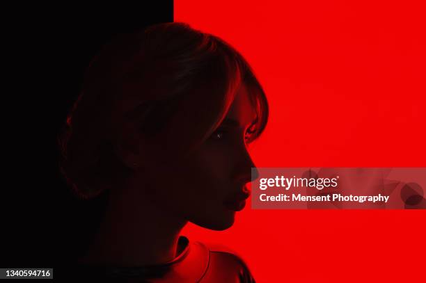 portrait of a transgender woman on a red glowing background - women wearing latex stock pictures, royalty-free photos & images