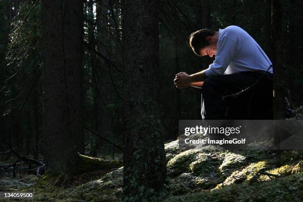 man praying in the forest - de sju dödssynderna bildbanksfoton och bilder