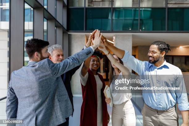 young successful business persons are having a meeting in office and celebrating sucess. - hi 5 stock pictures, royalty-free photos & images