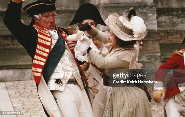 English actor Nigel Hawthorne as King George III is attacked by actress Janine Duvitski as would-be assassin Margaret Nicholson in a scene from the...