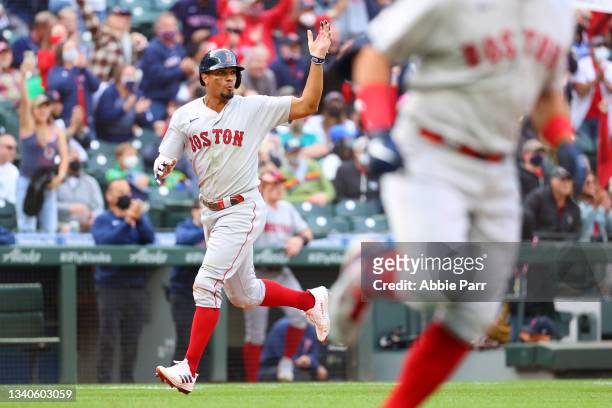 Xander Bogaerts reacts while scoring off a two-run single by Kyle Schwarber of the Boston Red Sox during the tenth inning against the Seattle...