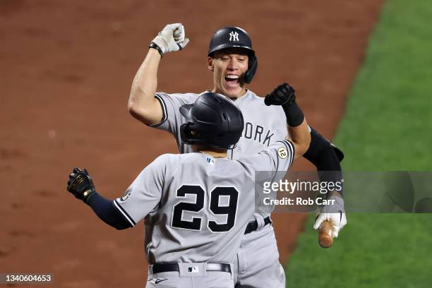 Gio Urshela celebrates his two RBI home run with Aaron Judge of the New York Yankees in the third inning against the Baltimore Orioles at Oriole Park...