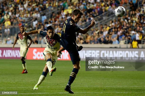 Salvador Reyes of Club America shoots past Leon Flach of Philadelphia Union during the first half during the semifinal second leg match between...