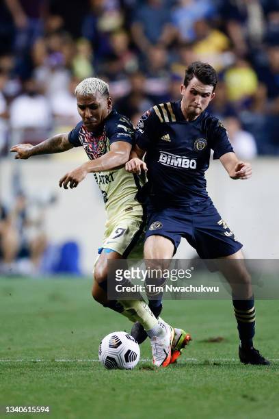 Roger Martínez of Club America and Leon Flach of Philadelphia Union battle for possession during the first half during the semifinal second leg match...