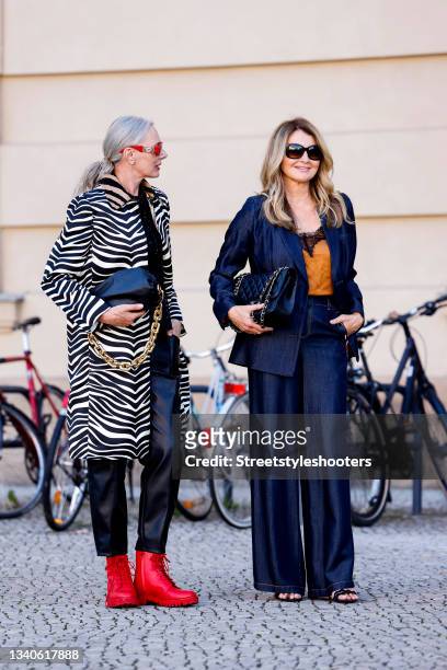 Best ager model Petra van Bremen, wearing a Zebra printed coat by Celine, a black blouse by Simone Rocha x H&M, black pants by Zara, red boots by...