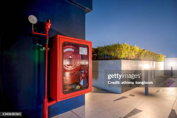 fire extinguisher and fire hose reel in the condo corridor. - fire extinguisher stock pictures, royalty-free photos & images