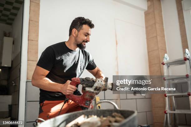 smiling worker does home renovation - mason bricklayer stock pictures, royalty-free photos & images