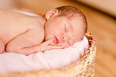 Sleeping cute newborn baby sleeps on round crib