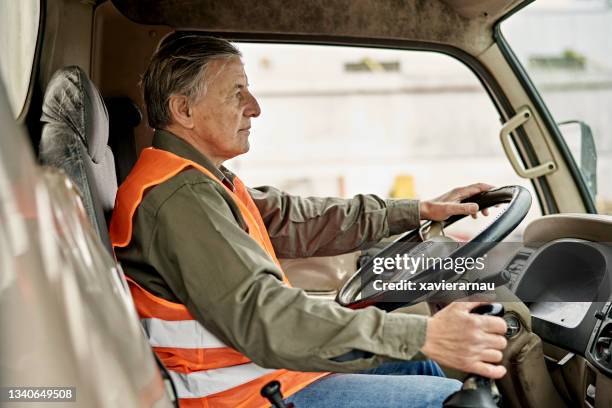 portrait of early 60s trucker sitting in driver’s seat - gear levers stock pictures, royalty-free photos & images