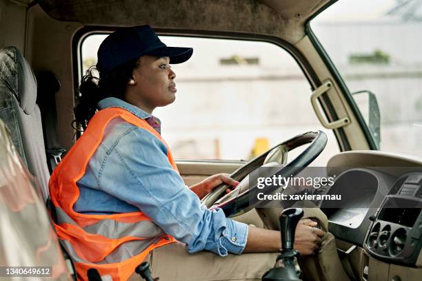 mid 20s female truck driver turning key in ignition - truck turning stock pictures, royalty-free photos & images