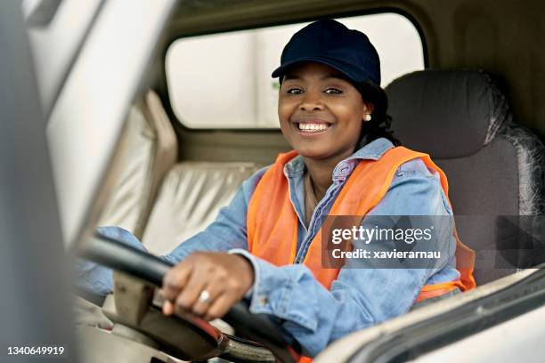 on-the-job portrait of black female trucker in cab - female driving stock pictures, royalty-free photos & images