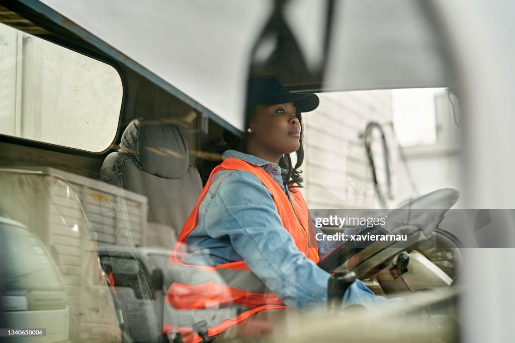 Black Female Truck Driver Photographed Through Window