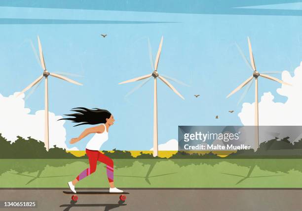ilustrações de stock, clip art, desenhos animados e ícones de carefree woman skateboarding along wind turbines in sunny field - womens free skate