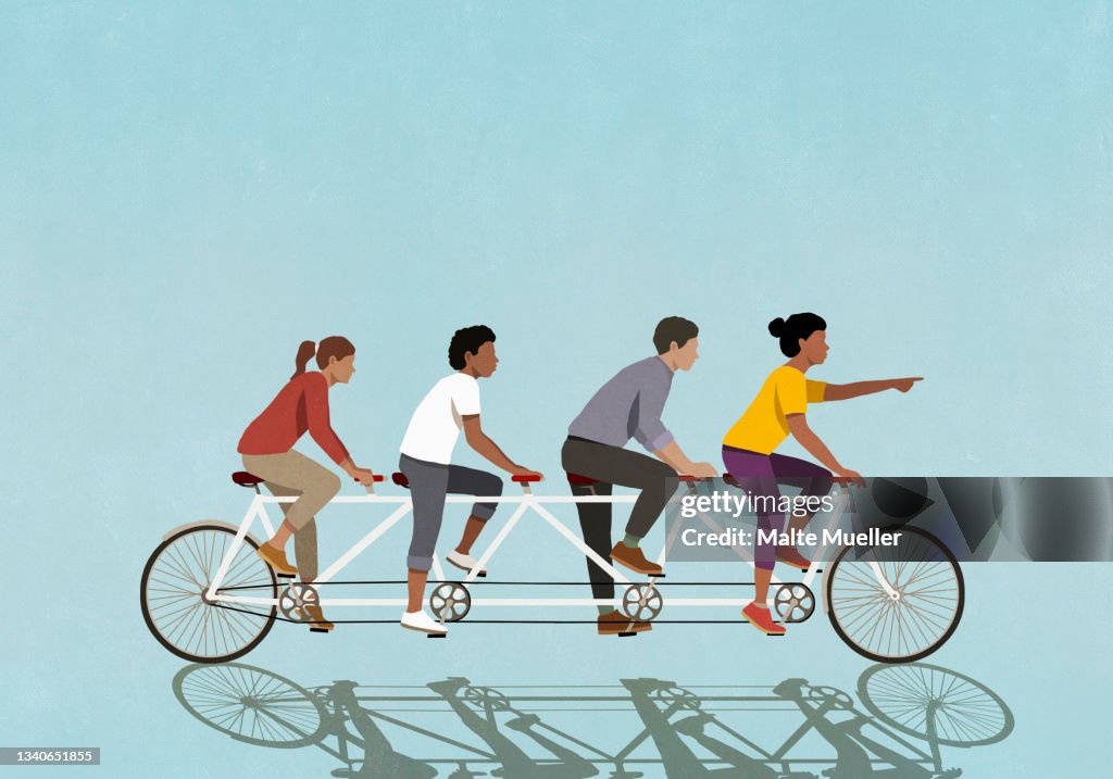 Friends riding tandem bicycle on blue background
