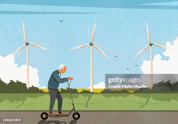 senior man riding electric push scooter along wind turbines in field - aktiver senior stock-grafiken, -clipart, -cartoons und -symbole