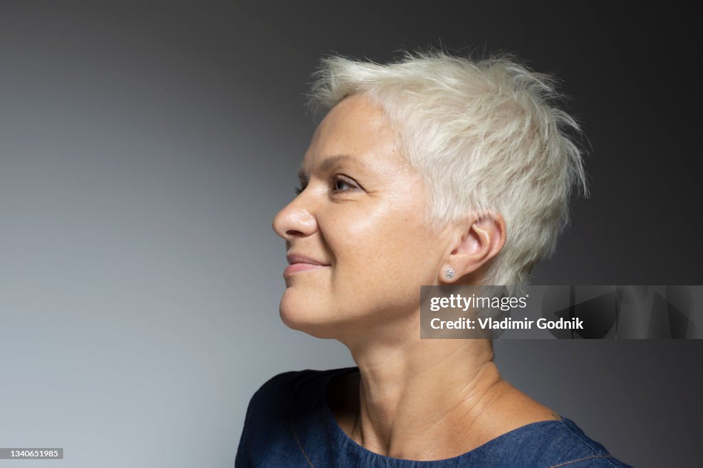 Profile portrait beautiful mature woman with short white hair