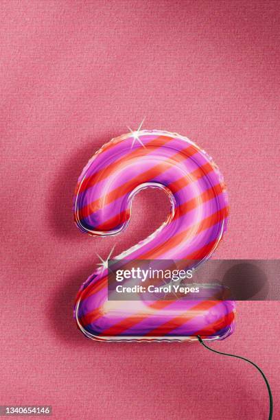 number two foiled balloon in pink color - number 2 balloon stock pictures, royalty-free photos & images