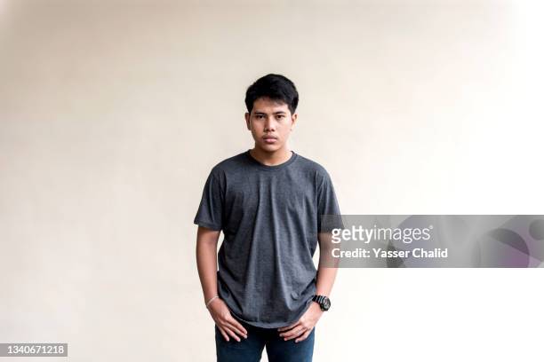 portrait of teenage boy looking serious - boy portrait studio stock-fotos und bilder