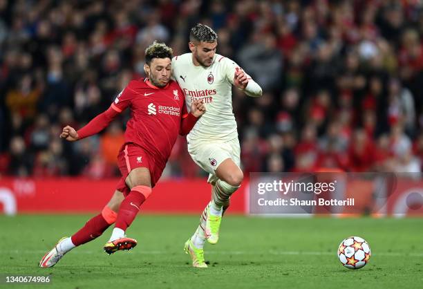 Theo Hernandez of AC Milan is challenged by Alex Oxlade-Chamberlain of Liverpool during the UEFA Champions League group B match between Liverpool FC...