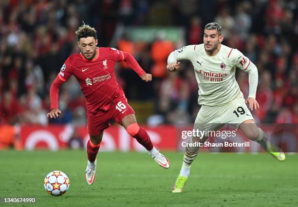 Theo Hernandez of AC Milan is challenged by Alex Oxlade-Chamberlain of Liverpool during the UEFA Champions League group B match between Liverpool FC...