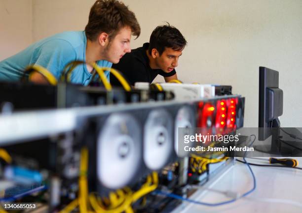 generation z working on cryptocurrency mining rig - bitcoin mining stock pictures, royalty-free photos & images