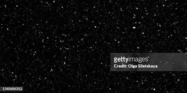 falling snow on black background - snow stock-fotos und bilder