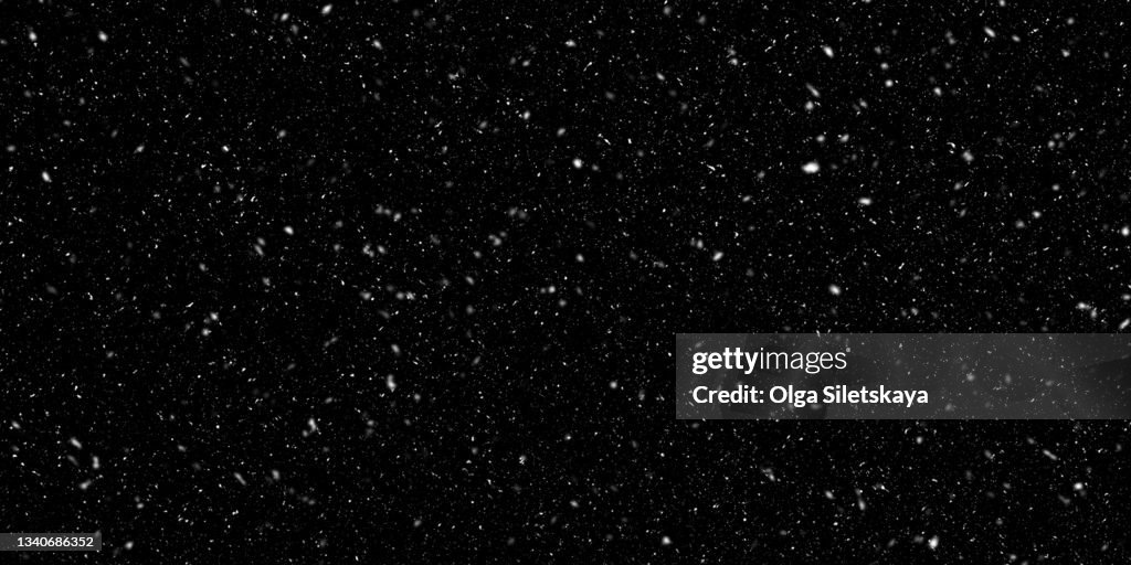 Falling snow on black background