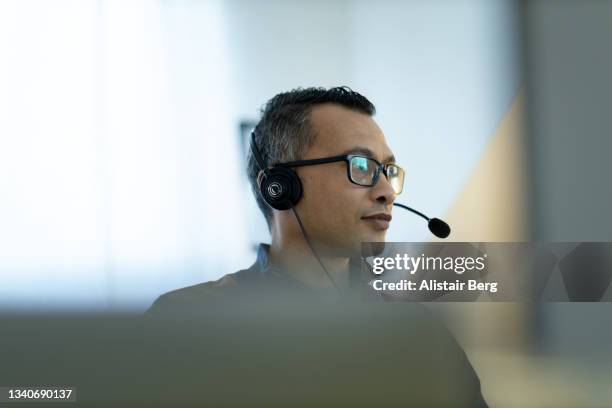 man working online from his home office - stock-brokers stock pictures, royalty-free photos & images