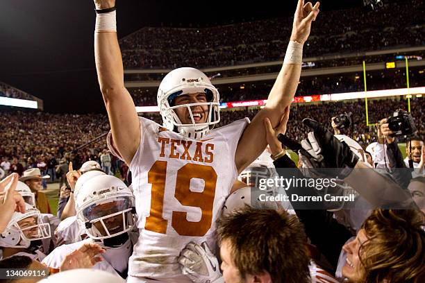 Justin Tucker of the Texas Longhorns celebrates with teammates after kicking the winning field goal as time expired in the second half of a game...