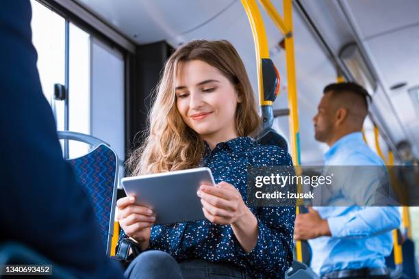 businesswoman using digital tablet in bus - tablet on bus stock pictures, royalty-free photos & images