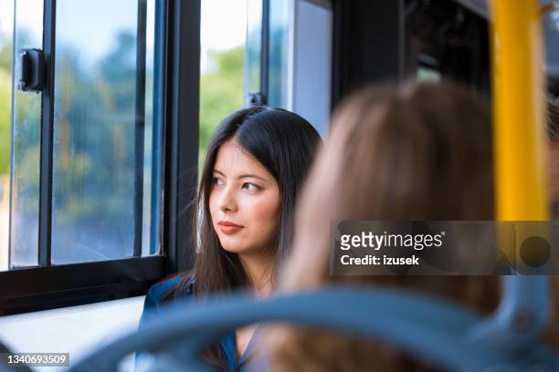 contemplated female traveling in bus - bus window stock pictures, royalty-free photos & images